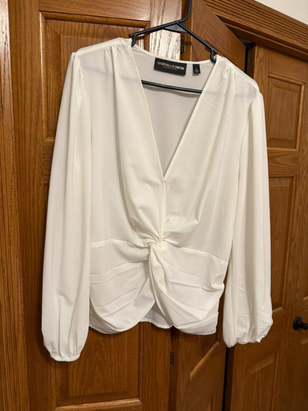 White blouse with wrap waist details. GUC